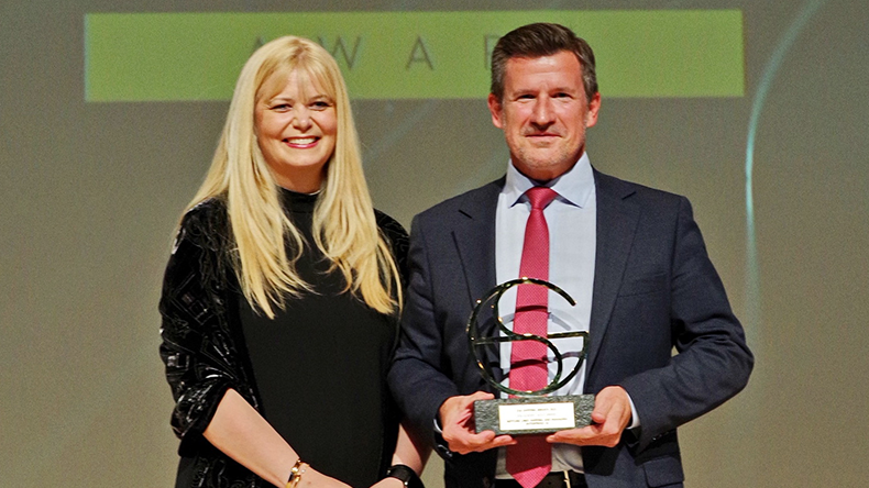  Neptune chief executive Craig Jasienski (right) accepts the ESG Leader Gold Award from Deloitte’s Alithia Diakatou