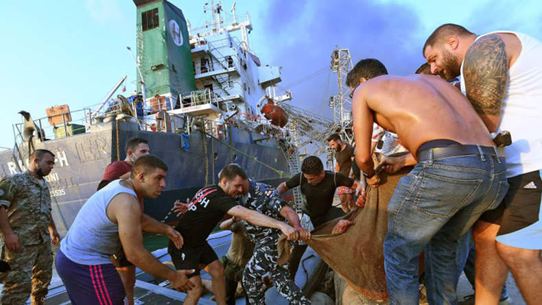Injured man being evacuated: the ship ifn the background is Raouf H, which was discharging its cargo of 5,500 tonnes of wheat on berth 9 at the time of the explosion and had 2 seafarers known to be killed. AFP via Getty Images