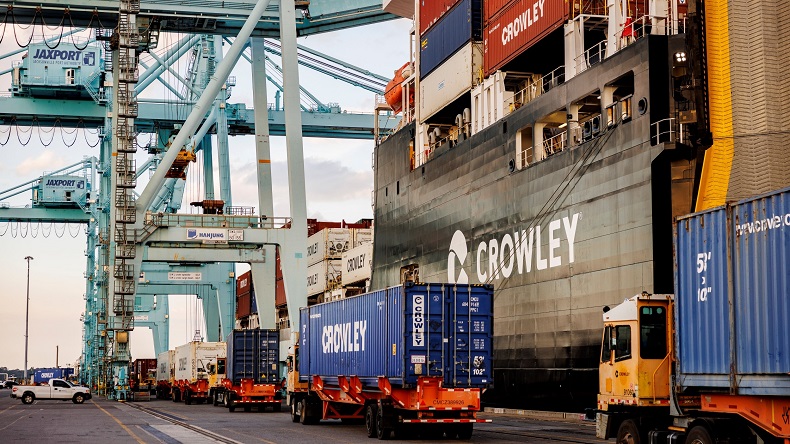 Crowley Logistics trucks unloading containers