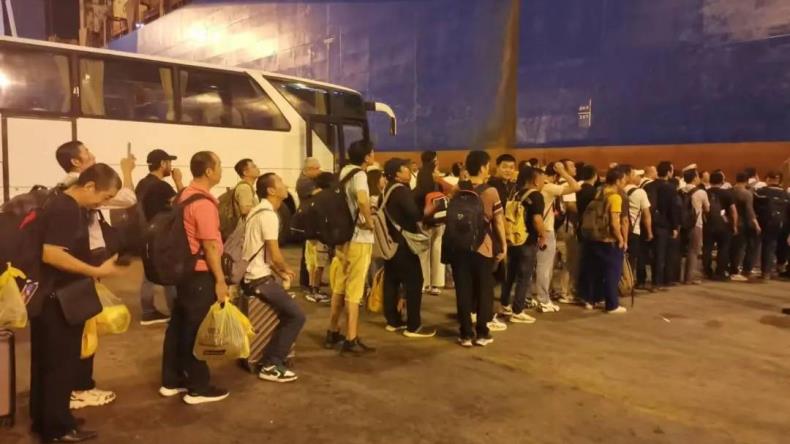 Chinese nationals in Lebanon line up to board a Cosco containership in the Port of Beirut