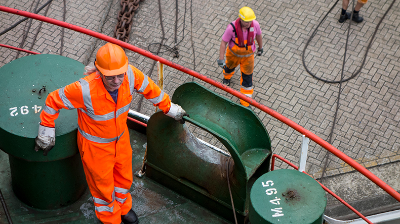 Seafarer in hi-vis jacket at port