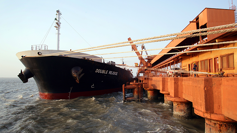 Ship loading bauxite mineral at the Kamsar port, Guinea