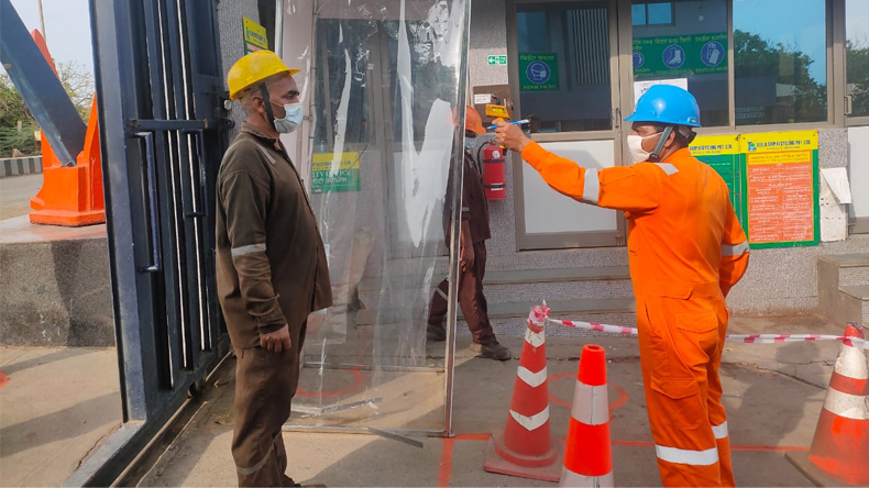 Temperature testing of a worker at Indian ship scrapyard