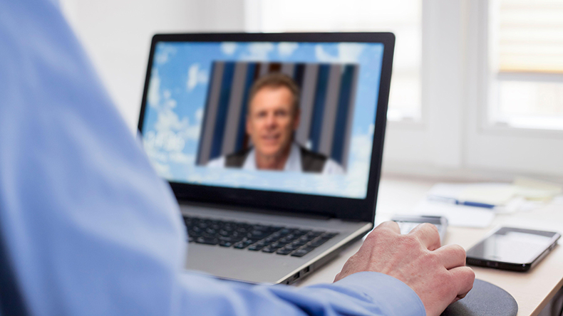 Two businessman talking online in a business meeting ArtmannWitte / Alamy Stock Photo