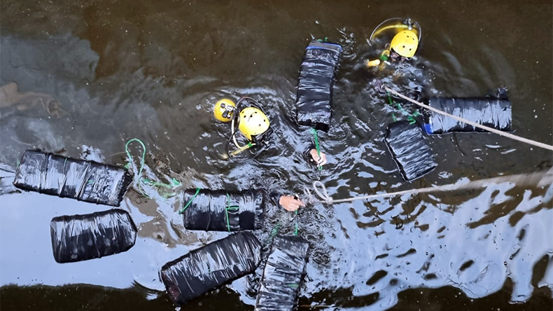 Divers in Brazil recover cocaine bales from water