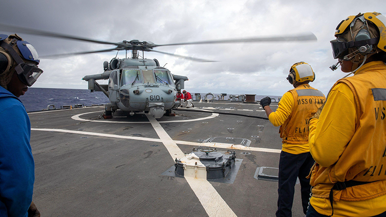 Sailors refuel an MH-60S Sea Hawk helicopter on the flight deck aboard the Arleigh Burke-class guided-missile destroyer USS O’Kane