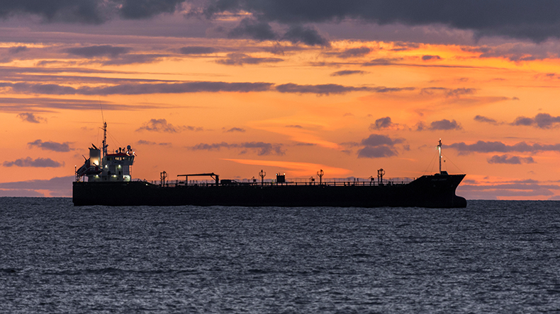 Oil tanker at anchor as dawn light breaks