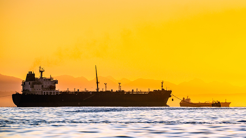 Oil tankers ship at sea on a background of sunset sky