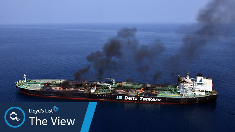Oil tanker on fire with black smoke on a blue calm sea